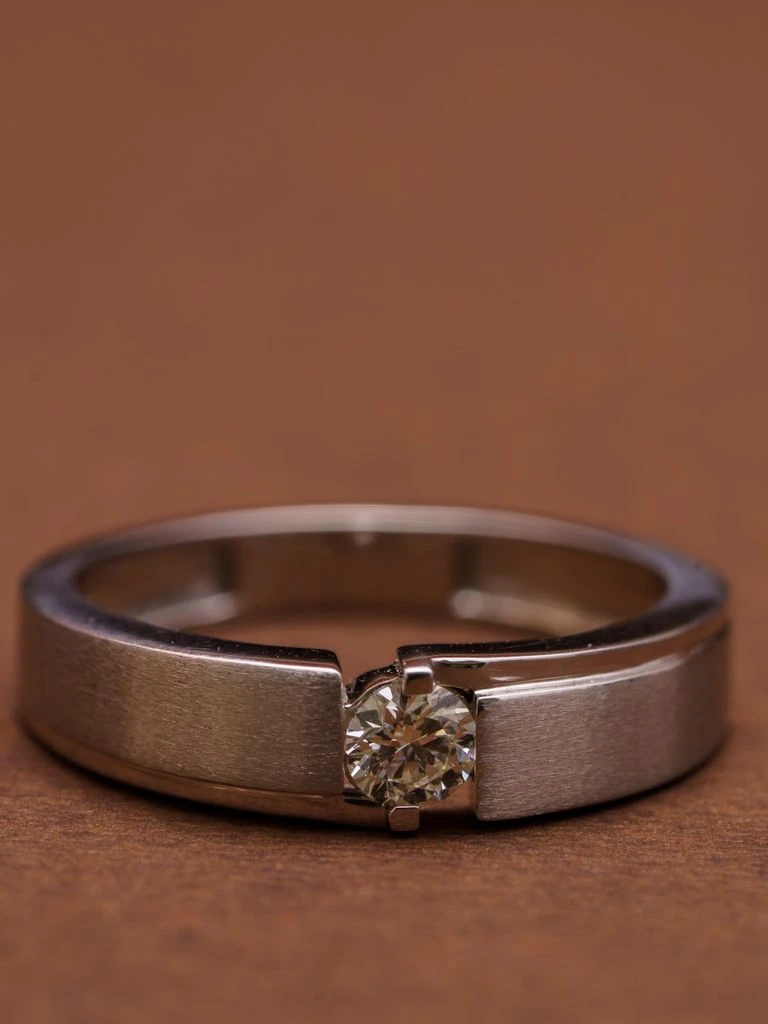 Platinum engagement ring with an emerald-cut diamond, photographed in the Lyon atelier